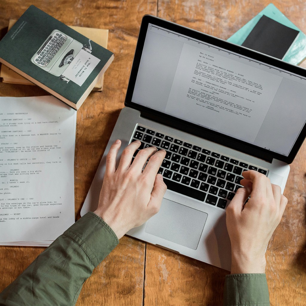 Person Using Macbook Pro on Brown Wooden Table Copywriting Image Ron Lach Pexels
